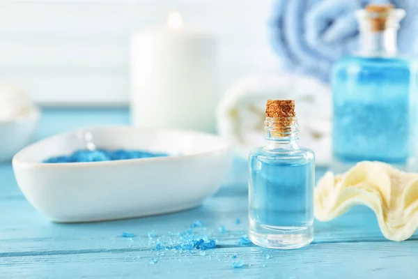 Bottle of essential oil for spa procedures on wooden table — Stock Photo, Image