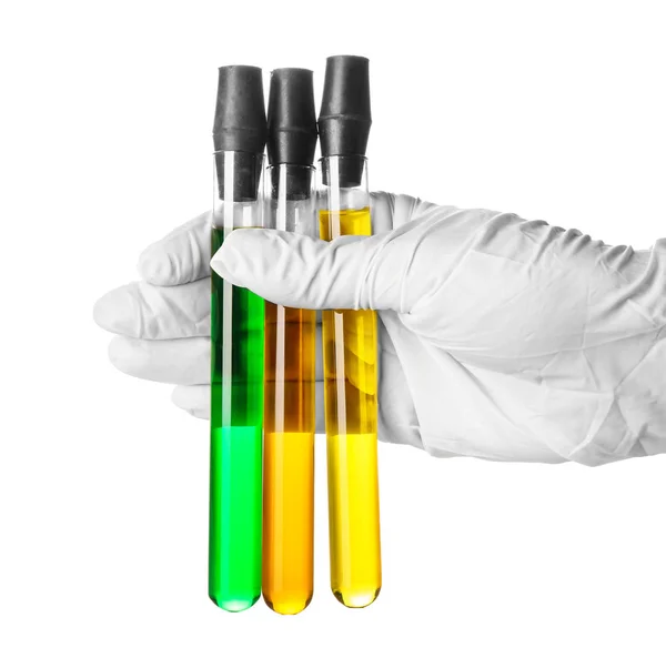 Hand in glove holding test tubes with color samples on white background — Stock Photo, Image