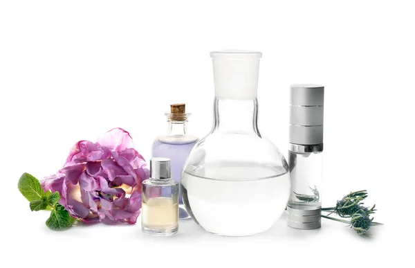 Composition with bottles of essential oils, ingredients and laboratory glassware on white background. Natural cosmetics — Stock Photo, Image