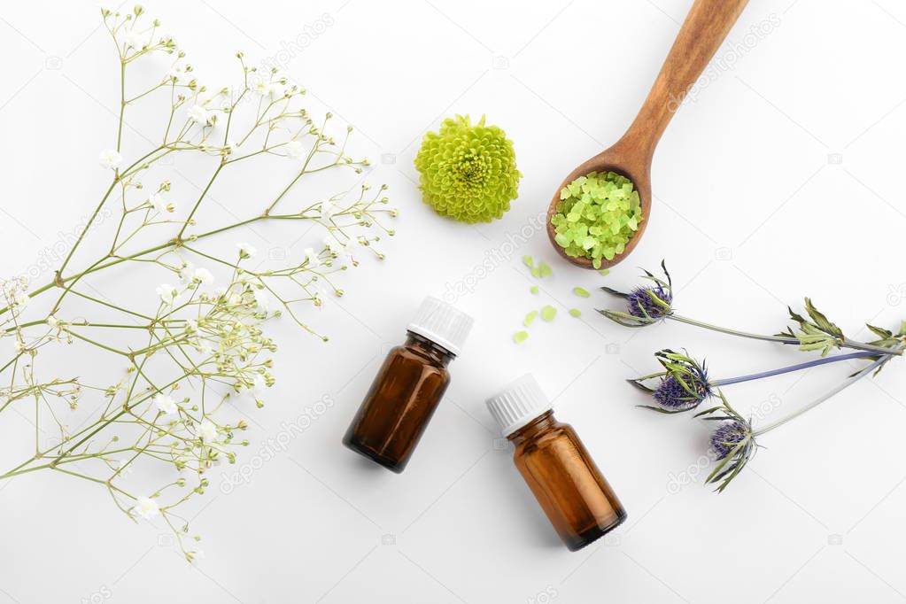 Composition with bottles of essential oils on white background. Natural cosmetics