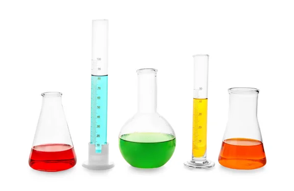 Laboratory glassware with liquids on white background — Stock Photo, Image