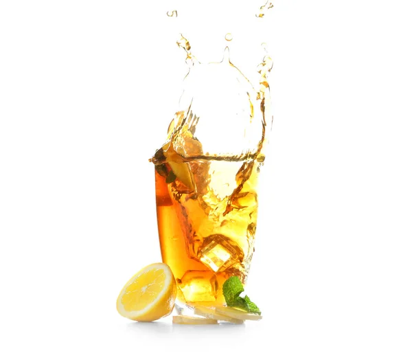 Glass and splash of delicious lemon tea with ginger on white background — Stock Photo, Image