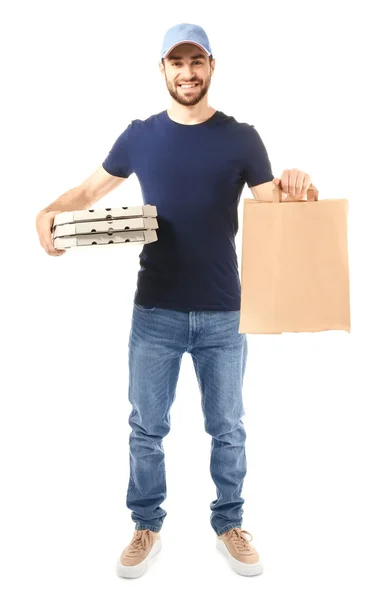 Delivery man with cardboard pizza boxes and paper bag on white background — Stock Photo, Image