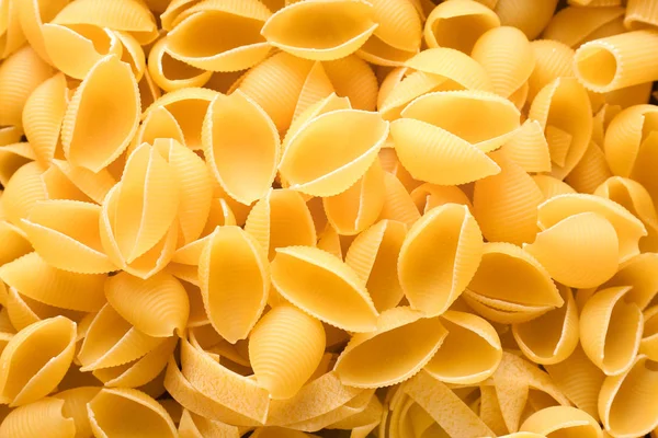 Uncooked pasta as background, closeup — Stock Photo, Image