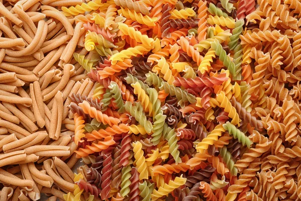 Uncooked pasta as background, closeup — Stock Photo, Image