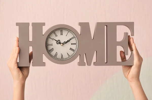 Mujer sosteniendo reloj decorativo sobre fondo de color. Concepto de gestión del tiempo — Foto de Stock