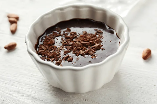 Bowl with molten chocolate on wooden background — Stock Photo, Image