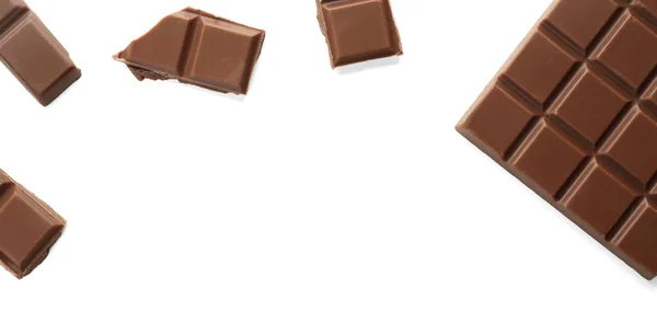Pieces of milk chocolate on white background — Stock Photo, Image