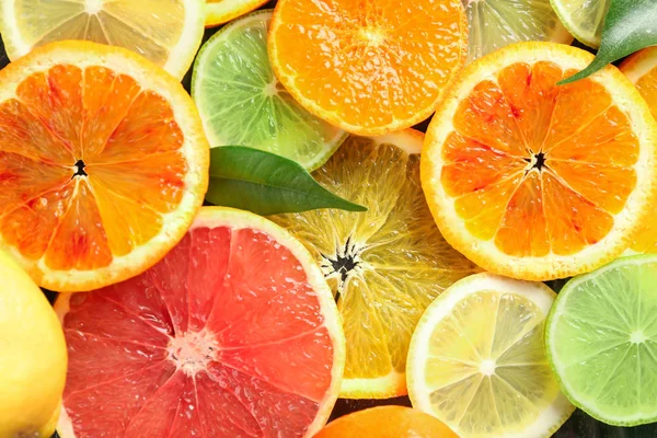 Slices of ripe citrus fruits as background — Stock Photo, Image