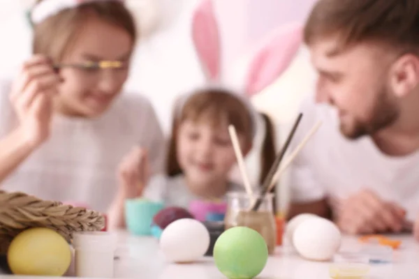 Malovaná velikonoční vajíčka a rozmazané rodiny na pozadí — Stock fotografie
