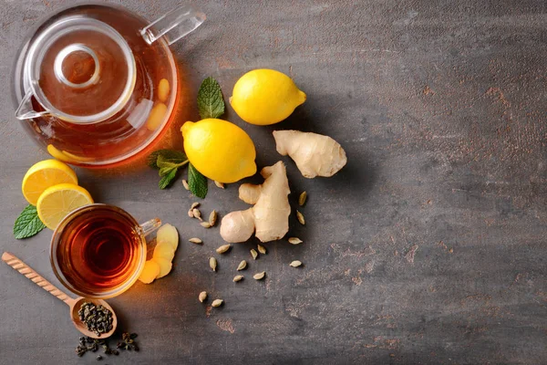 Flat lay composition with cup of hot tea, lemon and ginger on table — Stock Photo, Image
