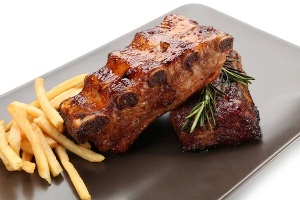 Plate with delicious grilled ribs and garnish on white background, closeup — Stock Photo, Image