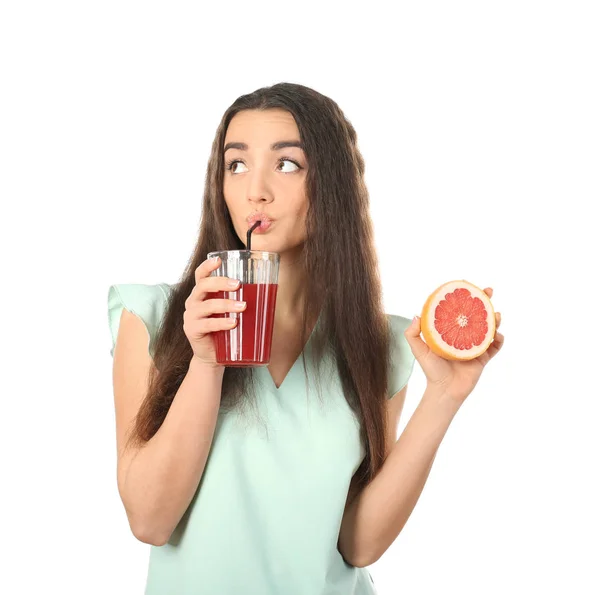 Beautiful young woman drinking citrus juice on white background — Stock Photo, Image