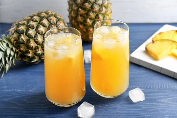 Glasses of tasty fresh pineapple juice on wooden table — Stock Photo, Image