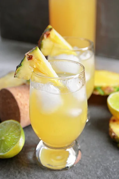 Glasses of tasty fresh pineapple juice on table — Stock Photo, Image