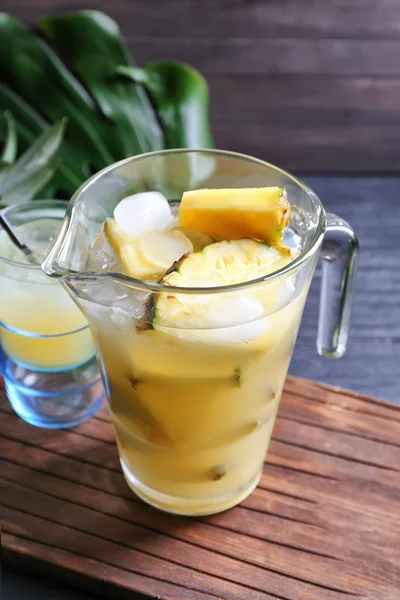 Glass jug with tasty fresh pineapple juice on table — Stock Photo, Image