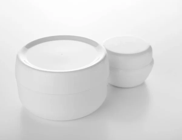 Jars of moisturizing cream on white background — Stock Photo, Image