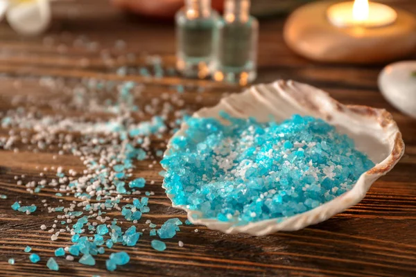 Sea salt for spa procedures on wooden table — Stock Photo, Image