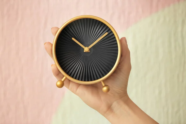 Woman holding alarm clock on color background. Time management concept — Stock Photo, Image