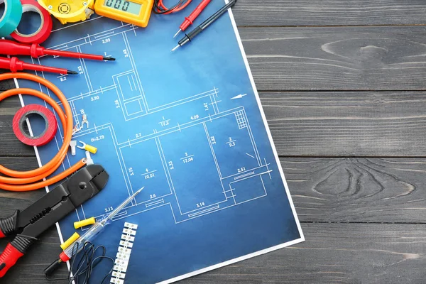 Flat lay composition with electrical tools and house plan on wooden background — Stock Photo, Image