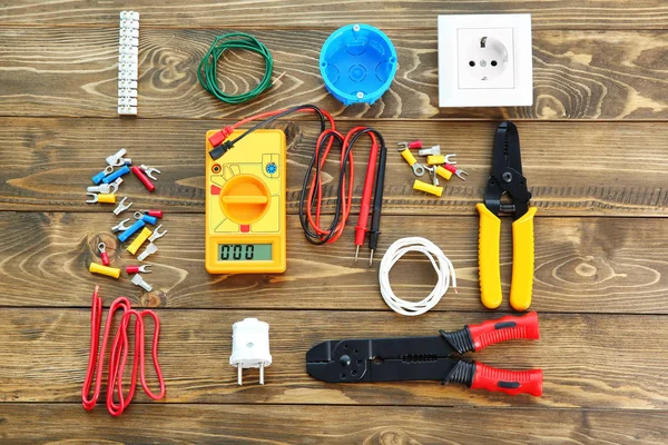 Flat lay composition with electrical tools on wooden background — Stock Photo, Image