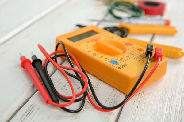 Multimeter on wooden table. Electrical tools — Stock Photo, Image