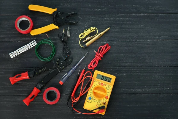 Flat lay composition with electrical tools on wooden background — Stock Photo, Image