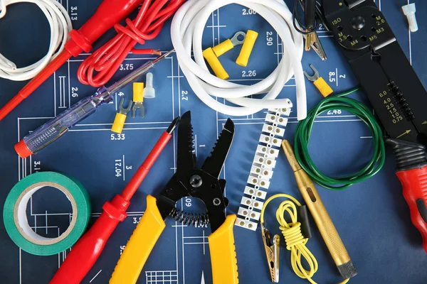 Flat lay composition with electrical tools on house plan — Stock Photo, Image