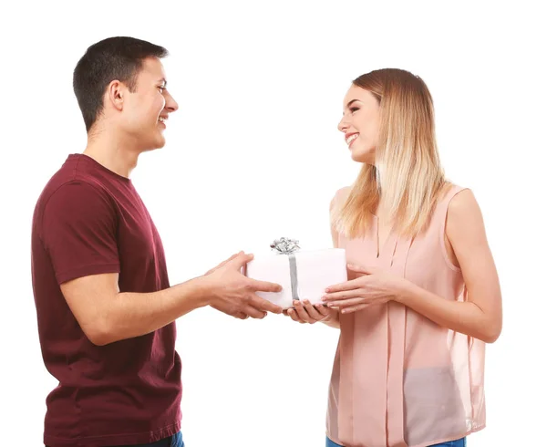 Young man giving present to his beloved girlfriend on white background — Stock Photo, Image