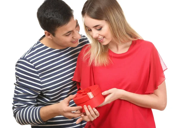 Young man giving present to his beloved girlfriend on white background — Stock Photo, Image