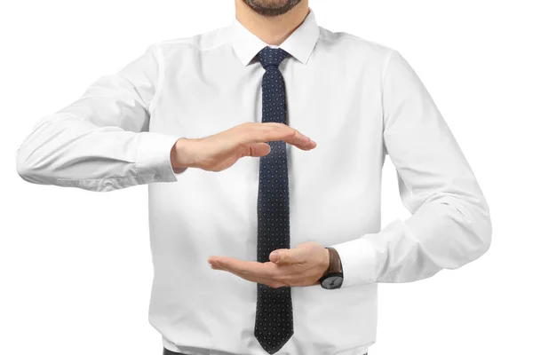 Young businessman holding something on white background — Stock Photo, Image