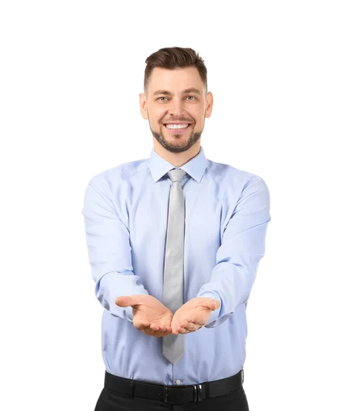 Joven empresario sosteniendo algo sobre fondo blanco — Foto de Stock