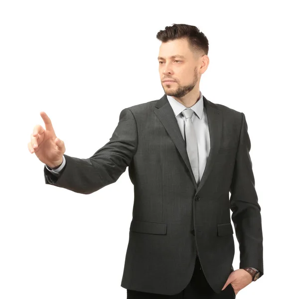 Young businessman using virtual screen on white background — Stock Photo, Image