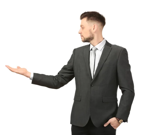 Young businessman holding something on white background — Stock Photo, Image