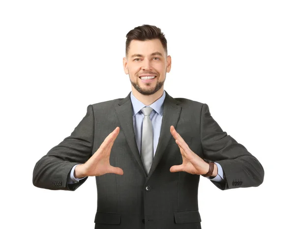 Young businessman holding something on white background — Stock Photo, Image