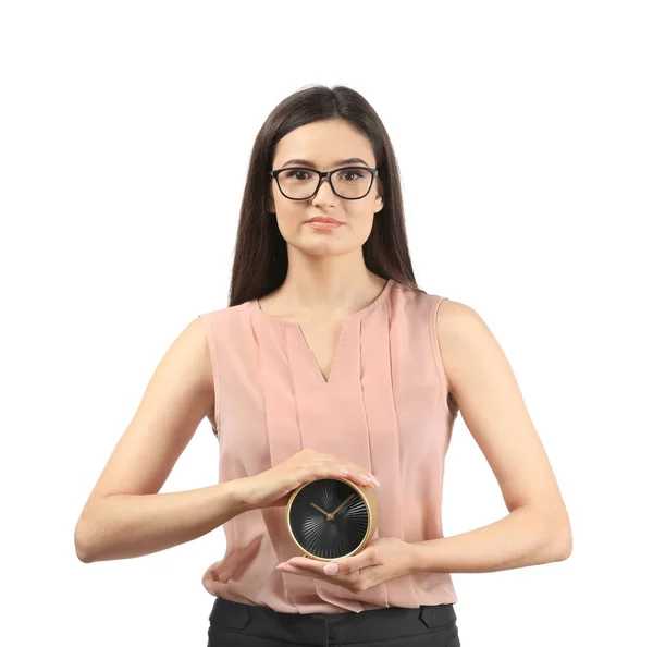 Young businesswoman holding alarm clock on white background — Stock Photo, Image