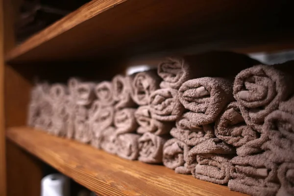 Clean soft towels on shelf in hairdressing salon