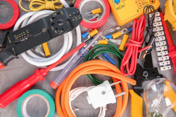 Flat lay composition with electrical tools on grey background — Stock Photo, Image