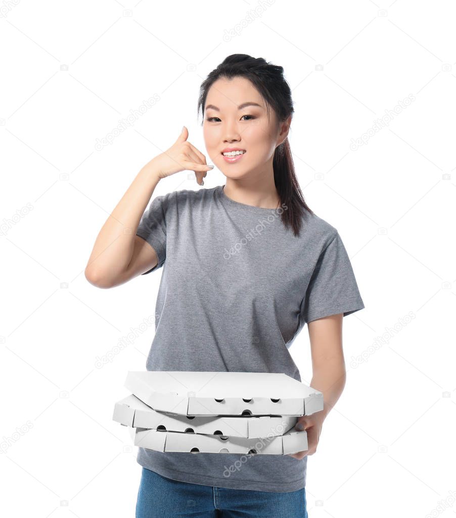 Asian woman with cardboard pizza boxes on white background. Food delivery service