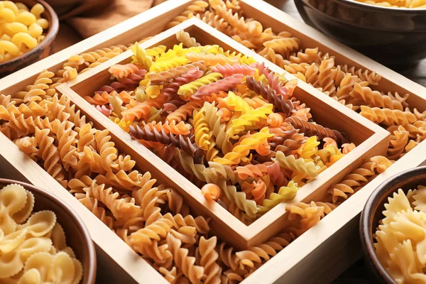 Different uncooked pasta on table, closeup