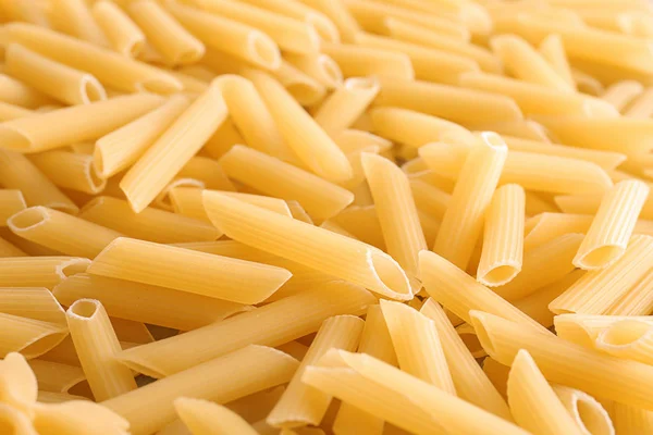 Uncooked pasta as background, closeup — Stock Photo, Image