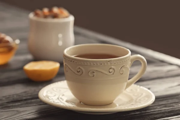 Cup with delicious tea on table — Stock Photo, Image