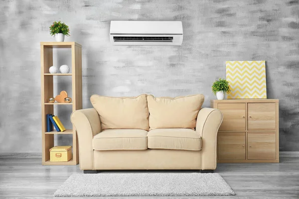 Living room interior with comfortable sofa and air conditioner