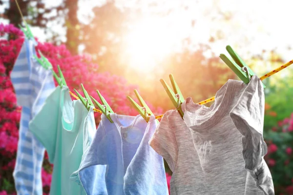 Rope with clean clothes outdoors on laundry day — Stock Photo, Image