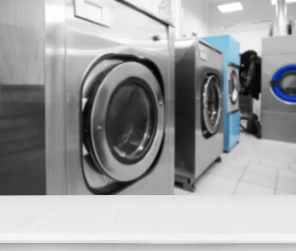 Table and washing machines at self-service laundry