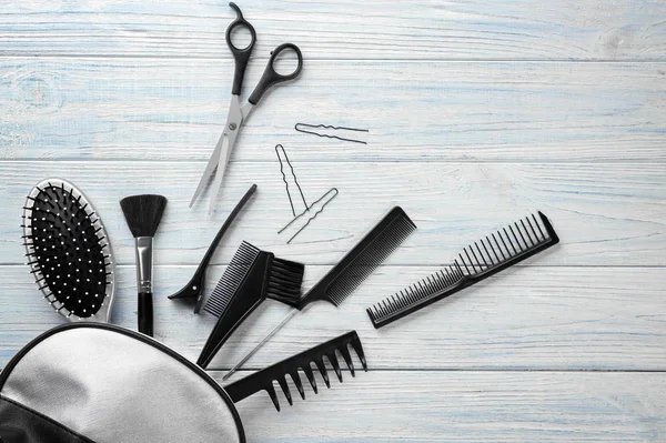 Flat lay composition with professional hairdresser's tools on wooden background — Stock Photo, Image