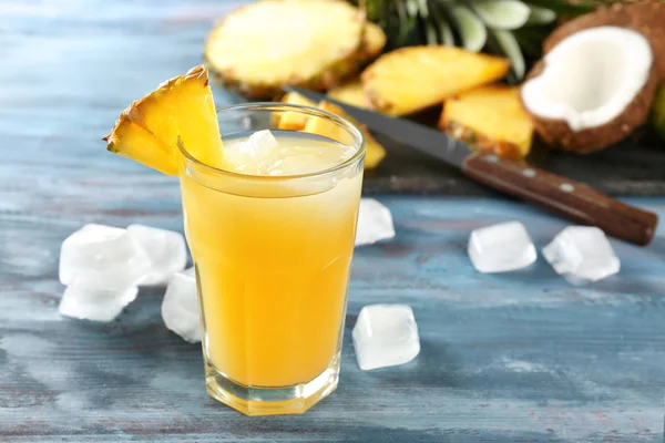 Glass of sweet pineapple juice on wooden table — Stock Photo, Image