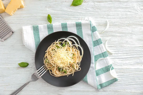 Plate of delicious pasta with cheese and herbs on white wooden table — Stock Photo, Image