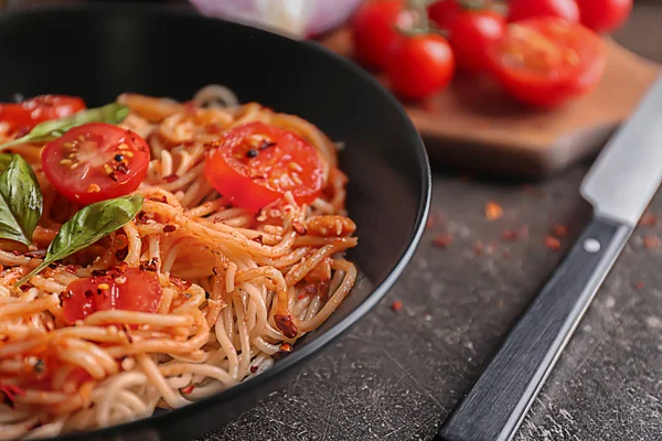 Plate of delicious pasta with tomatoes on table, closeup — Stock Photo, Image