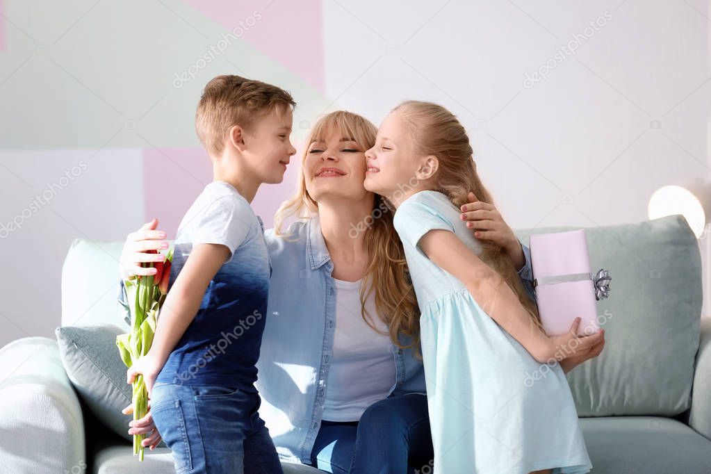 Cute little kids congratulating their mother at home